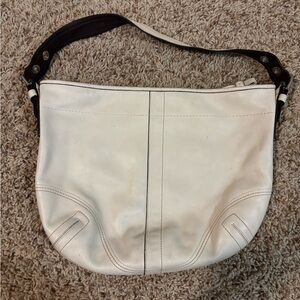 Over the shoulder cream Coach purse.